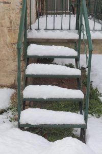 My landlord did not clear snow or ice from a staircase and I fell